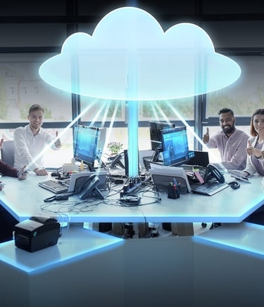 Six adults gesturing thumbs up while sitting around computer displays with a graphic of a cloud above their heads.