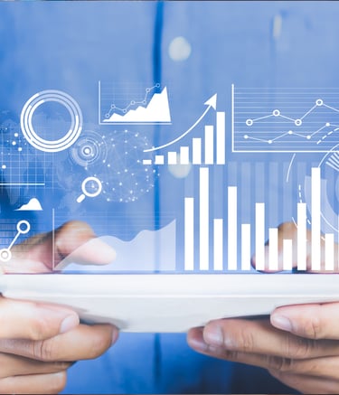 Professional businessman using a digital tablet with futuristic data analytics charts and financial graphs overlay.