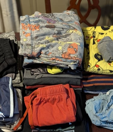 Folded family laundry including kids clothes prepared for wash dry fold service in Athens, AL