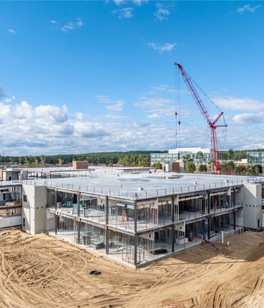a crane is in the foreground of a construction site