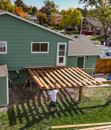 Drone view of overhead deck framing structure under construction by Brewer Construction in Denver