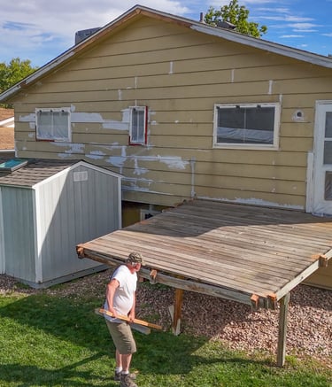 Old wood deck removal and backyard site preparation by Denver contractor Brewer Construction at Iris Court.