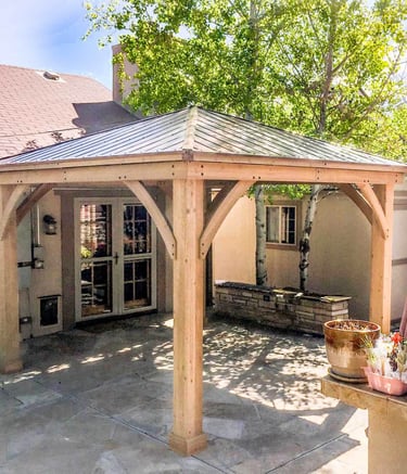 Completed custom wood pergola and integrated ceiling fan on a Denver, Colorado backyard patio.