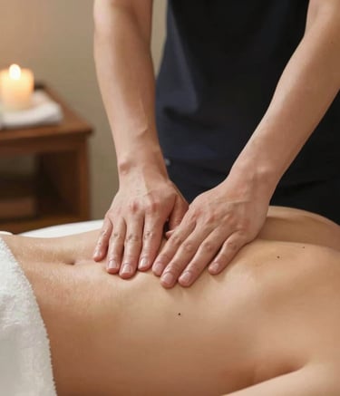 Comfortable massage table with fresh linens in a softly lit room.