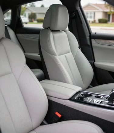 A detailed shot of a luxury car interior after an elite detail package. The leather seats are matte and perfectly clean, and the center console is free of dust, shot in a North American suburban setting.