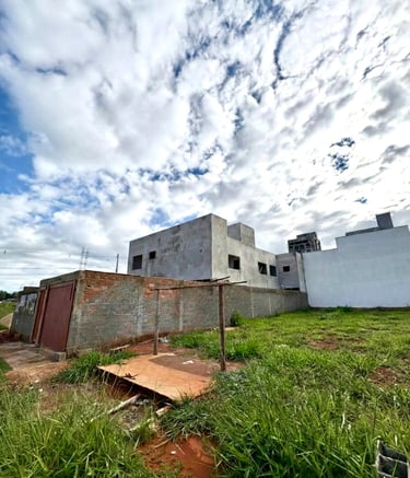 a building with a fenced in area with grass