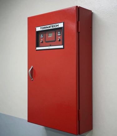 A high-resolution industrial photograph of a Tornatech fire pump control panel mounted on a wall in a clean utility room. The panel is a deep red, contrasting with the cool off-white and soft grey-blue surroundings. The lighting is sharp and professional, emphasizing the modern engineering and reliability of the equipment.