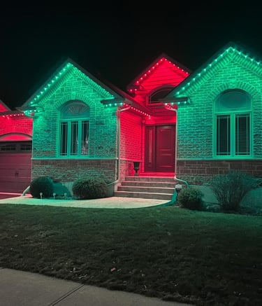 Bright LED outdoor lights decorating the roofline and windows of a house.