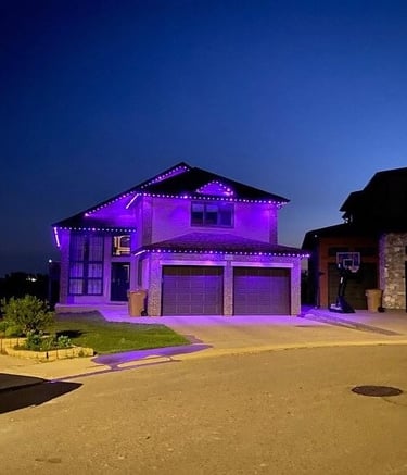 Bright LED outdoor lights decorating the roofline and windows of a house.