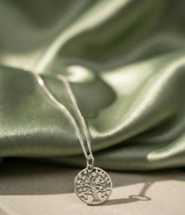 a silver necklace with a tree on it