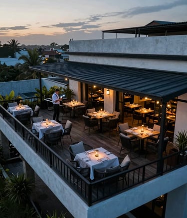 Photography of a drone capturing high-angle footage of a luxury restaurant terrace in Latin America, showing elegant furniture and a professional setup, sunset lighting, colors: muted blue and black.