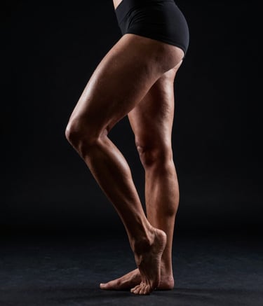 Four friends with backpacks raising arms in forest.