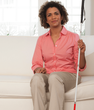 Professional woman with astigmatism and cane for the blind
