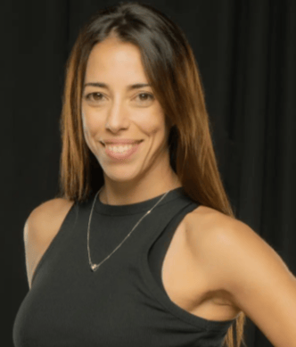 a woman in a black top and a necklace