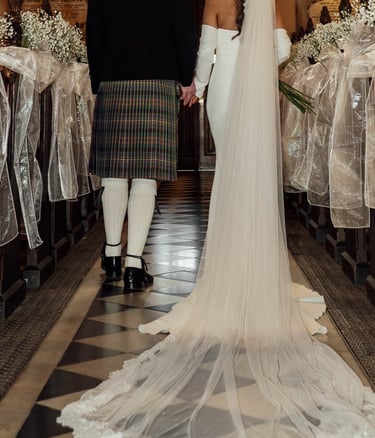 a bride and groom are standing in a church