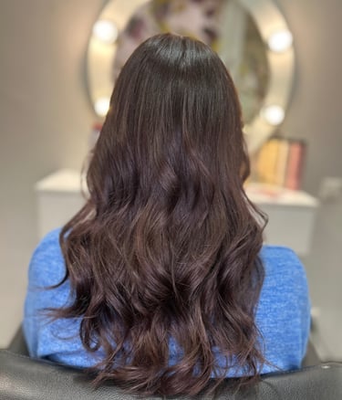 a woman with long hair and a blue sweater