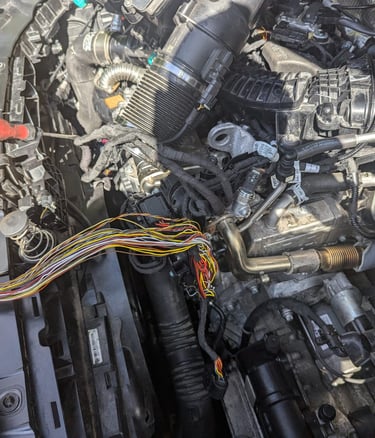 a man working on a car engine in a car