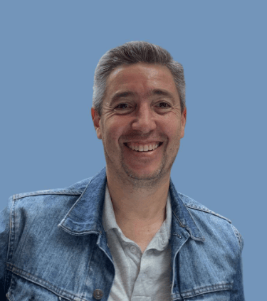 a man in a denim jacket and jeans jacket