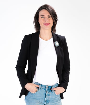 Rachel Hahn, a copywriter and owner of RC Copy & Creative Strategy, wearing jeans and a black blazer