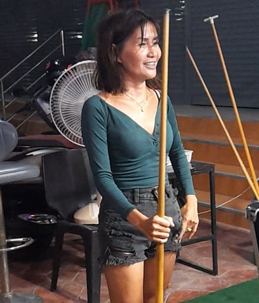 Thai woman playing pool at Station Bar, near Soi 94 in Hua Hin