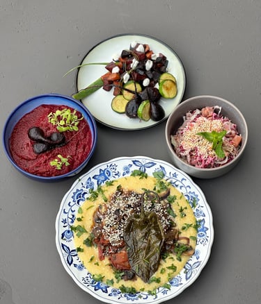 a table with bowls of food and vegetables