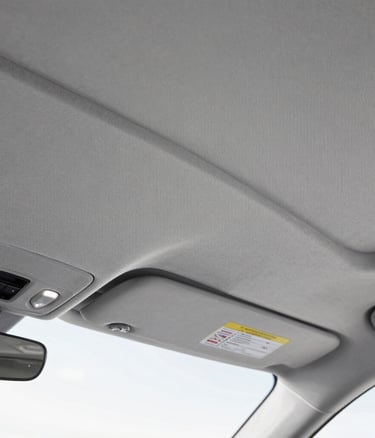 Smooth tan leather car seat with precise stitching