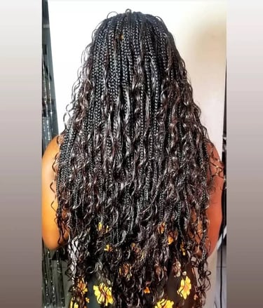 a woman with curly goddess braids