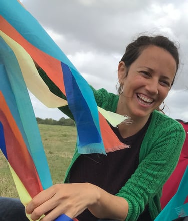 a woman sitting in a hammock with a baby