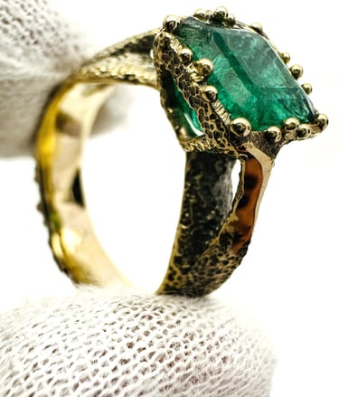 a ring with a green EMERALD stone