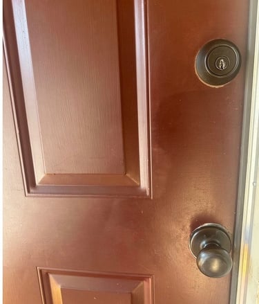Red home door with deadbolt and knob representing residential locksmith services Candler, NC 