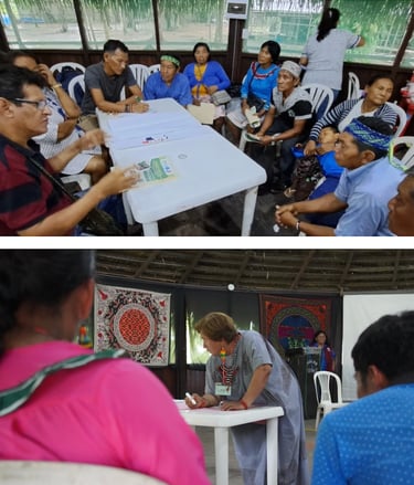 Indigenous Amazonian people attending a community workshop and planning meeting in a traditional building.