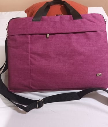 a laptop bag with a laptop on a bed