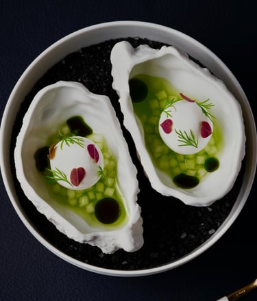 Gordon Ramsay High Gourmet oyster dish with fresh garnishes.