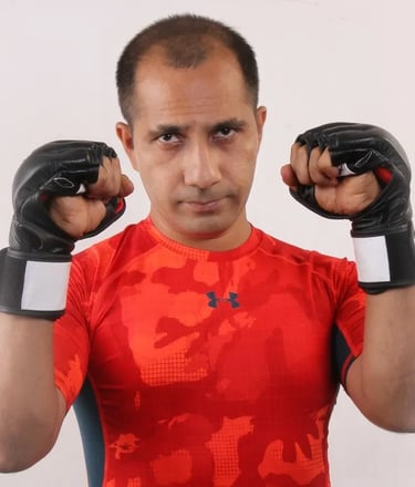 a man in a red shirt and black gloves