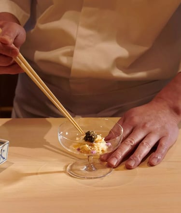Master chef preparing a luxurious dish with caviar at an omakase dining experience in London.