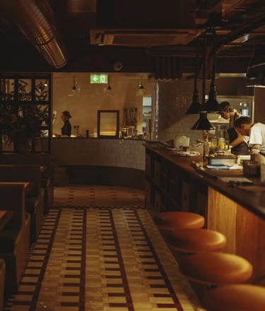 Moody open kitchen at Don't Tell Dad, a top London restaurant, where chefs craft exquisite dishes.