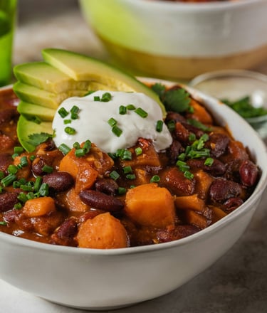 Bowl with vegan chili sin carne with beans, vegetables, vegan topping yogurt and avocado