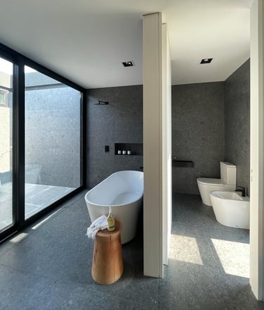 a bathroom with a tub and a tub in the middle of the room