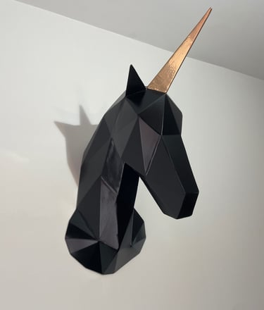 a black and gold unicorn headpiece with a gold horn horn