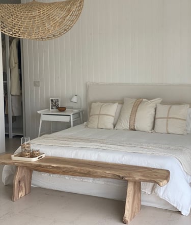 a bed with a wooden bench and a bench with a bench and a table with