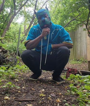 Man posing outdoors in his pup hood.
