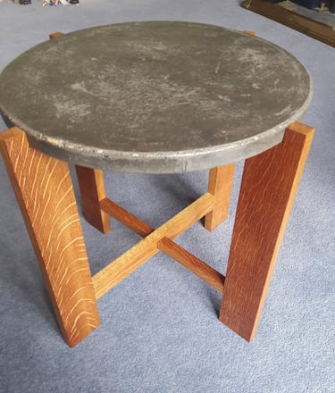 Coffee table made from 4 oak legs with cross pieces topped with a circular concrete top