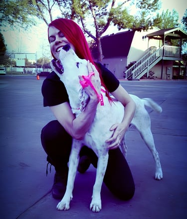 Rock of Love star and Heroes K9 Rescue founder, Lacey Sculls, hugging a rescued dog