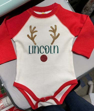 Infant's baseball onesie, white with red sleeves, personalized with child's name and reindeer antlers and nose.