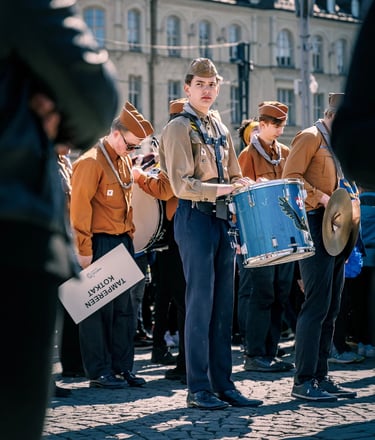 a man in a uniform is holding a drum and a drum