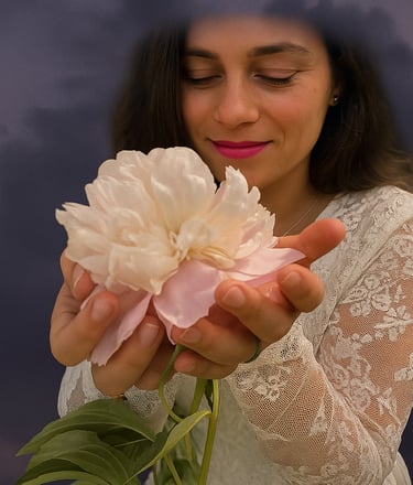 a woman holding a flower in her hands