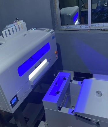 a DTF machine turned on, with bright blue lights shinning from it.