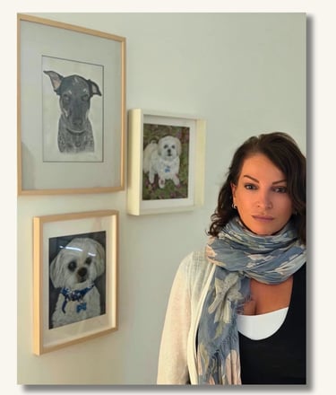 Australian pet portrait artist Sharan with framed dog portraits in her Gold Coast studio.