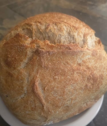 Heritage whole wheat sourdough boule with golden scored crust, baked fresh to order at Mandy's Mount