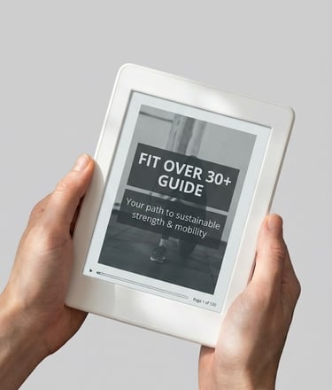 Hands holding a white tablet displaying a Fit Over 30 fitness guide for strength and mobility.